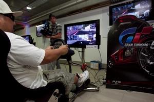 A competitor 'racing' with Gran Turismo 5 on the VisionRacer system